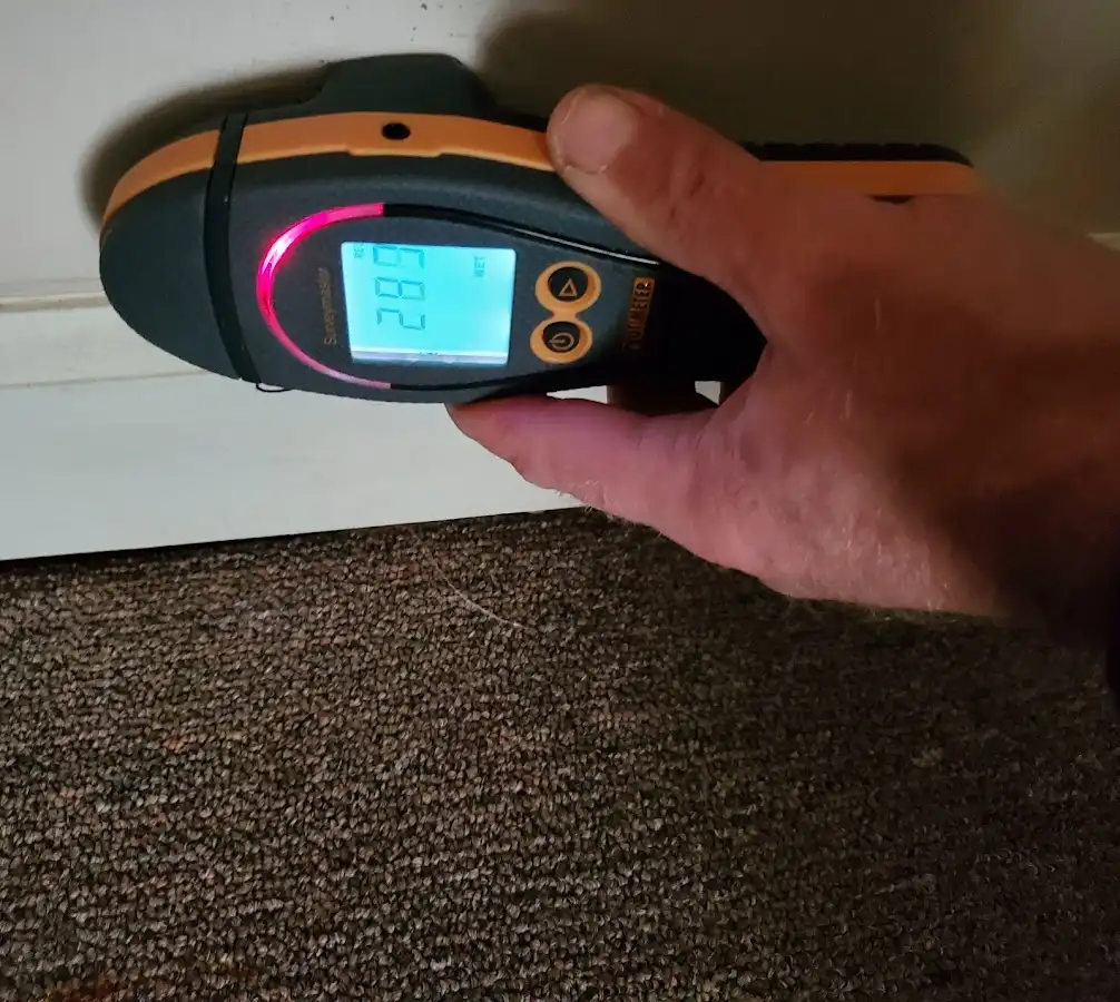 Moisture detection at baseboard during Storm Damage Restoration in White City